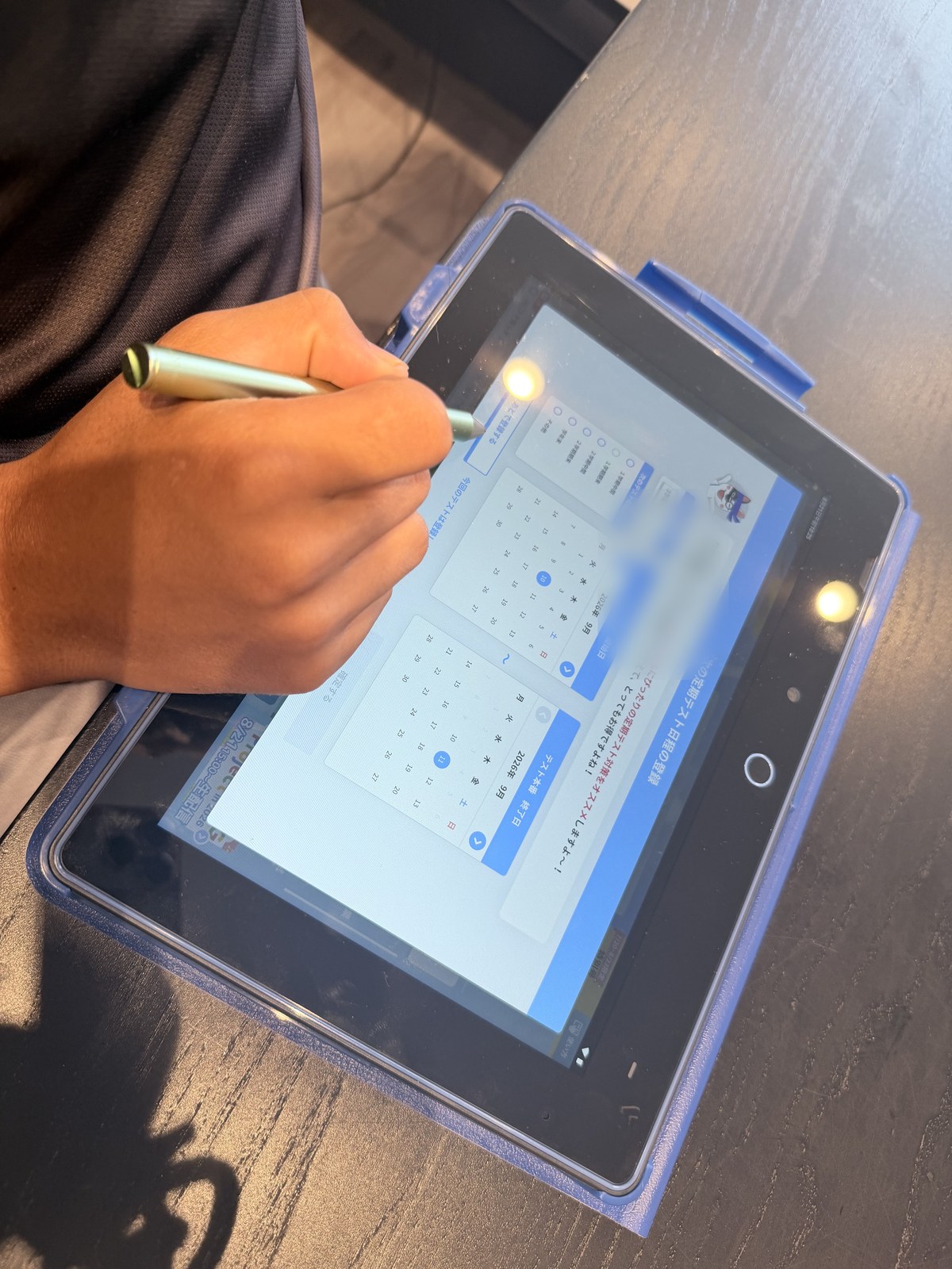 チャレンジタッチで定期テストの日程を登録する中学生の手元